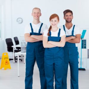 Team of workers in matching blue coveralls and white shirts, representing custom embroidered uniforms in Australian workplaces for 2025.